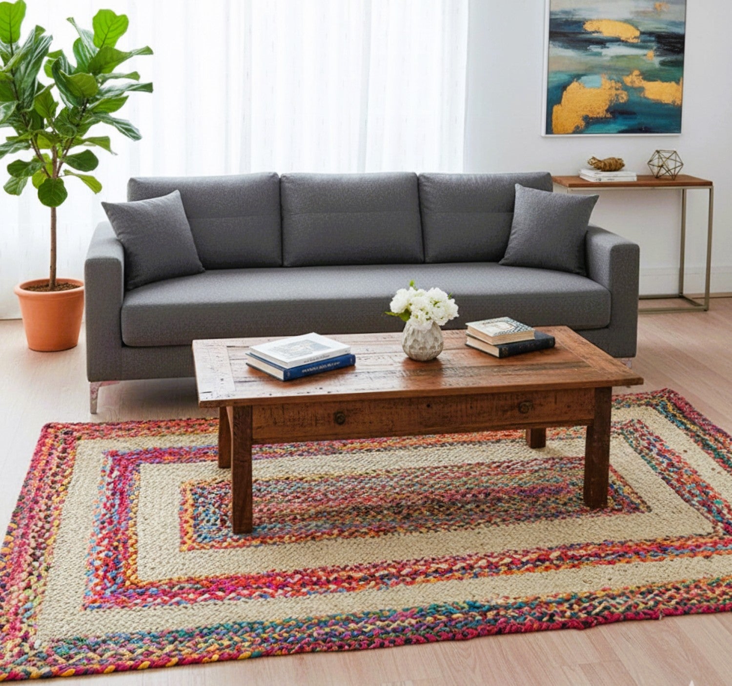 Living room with a gray sofa, wooden coffee table, and colorful rug.